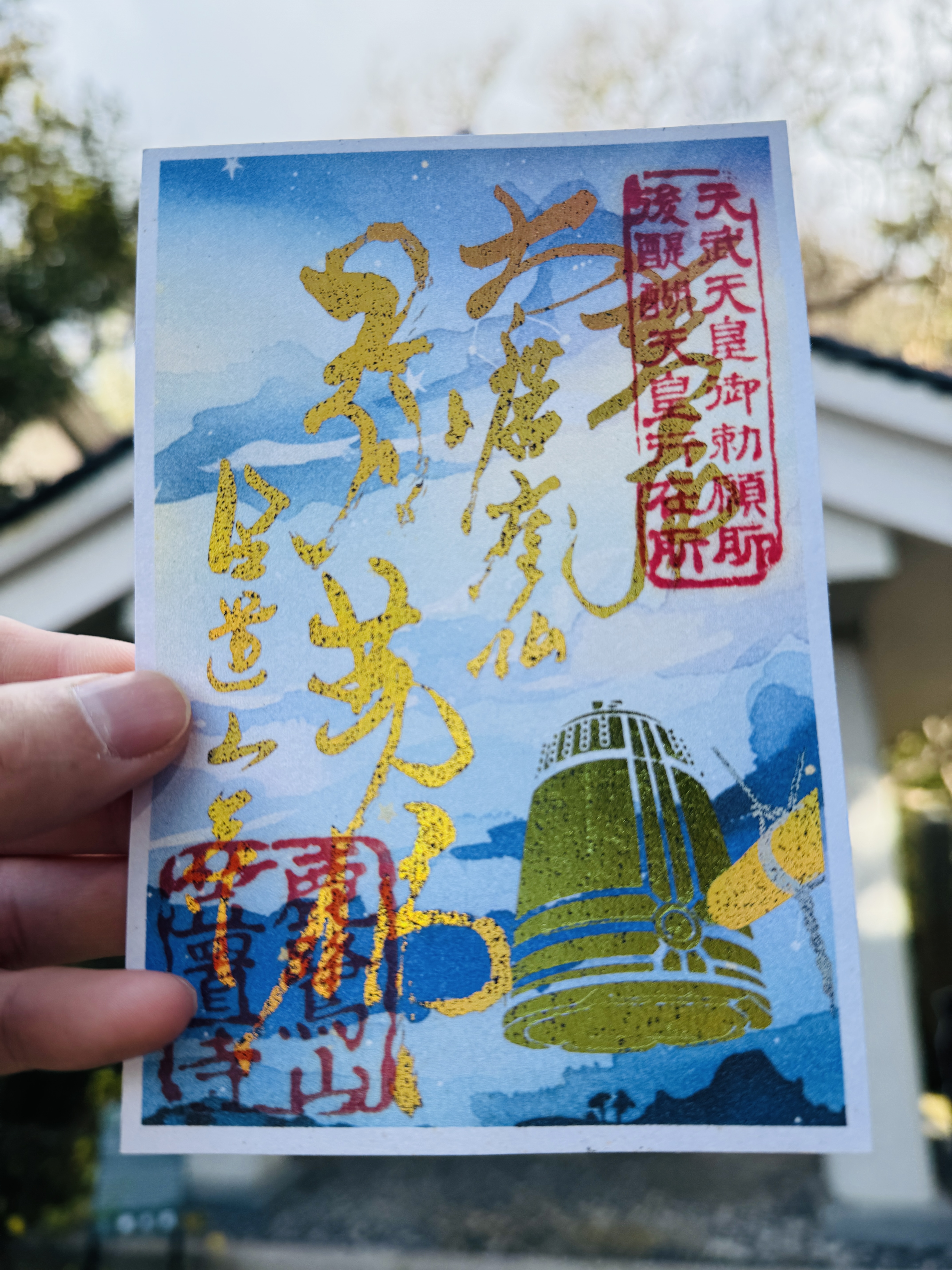 笠置寺の12月限定御朱印。夜空と除夜の鐘が描かれた台紙に、金色の箔押しで文字が書かれた華やかなデザイン。